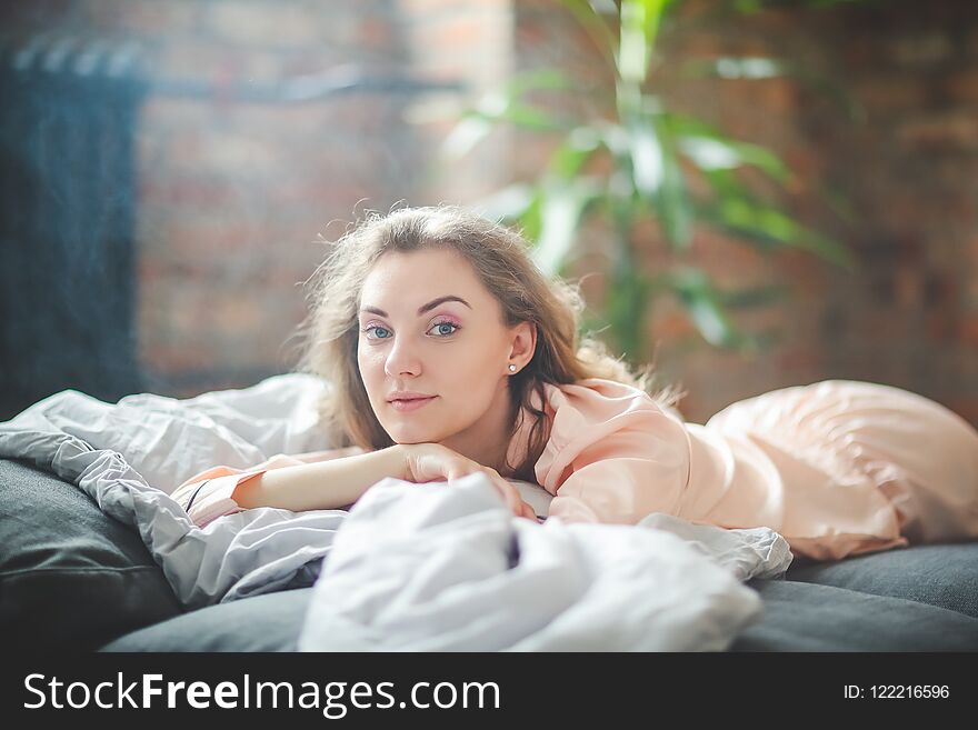 Morning leisure. Woman is lying on the bed. Morning leisure. Woman is lying on the bed