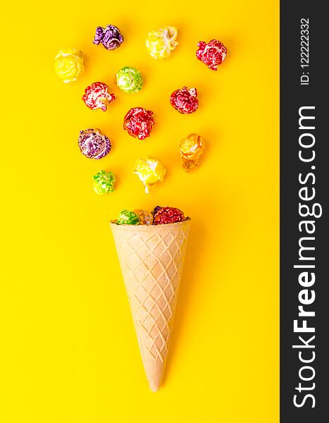 Sweet colored popcorn on bright background