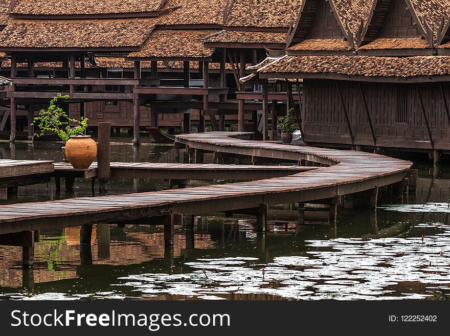 Peaceful thai floating architecture with traditional wooden house and bridge in Ancient City