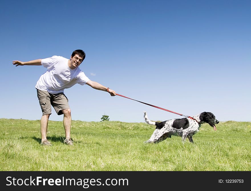 Man playing with his dog on the fields