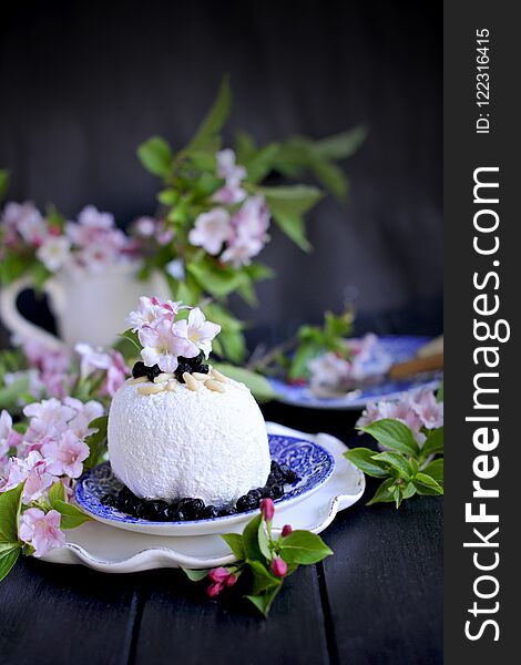 Sweet Dessert Of Cheese, On A Dark Background With Fresh Flowers