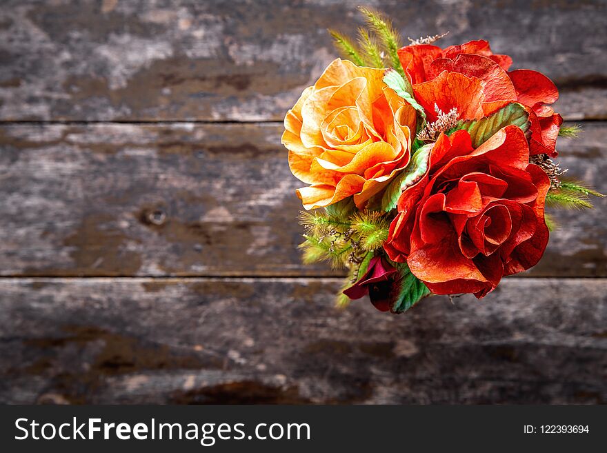 Top view on bouquet of colorful blooming flowers with space on blurry grunge wooden table. Top view on bouquet of colorful blooming flowers with space on blurry grunge wooden table.