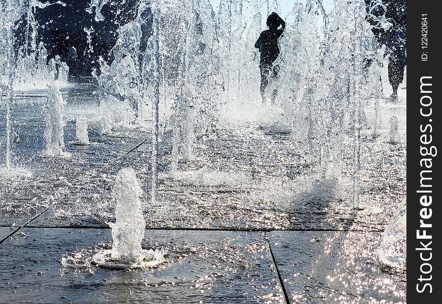 Child Is Playing In Dry Fountain On Hot Sunny Day in Summer. Child Is Playing In Dry Fountain On Hot Sunny Day in Summer