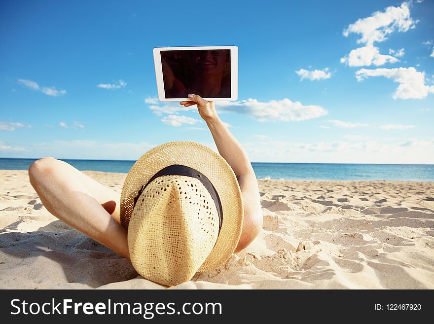 Modern Woman In Swimsuit On Seashore Using Tablet PC