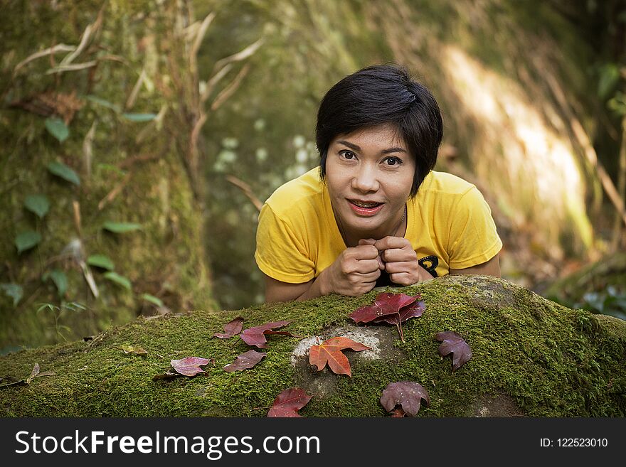 Portrait of a nice Asian girl holding with dry red-yellow maple