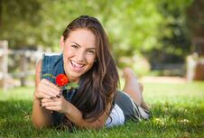 Laughing Mixed Race Teen Laying In Grass With A Flower Stock Images Laughing Mixed Race Teen Laying In Grass With A Flower Stock Images