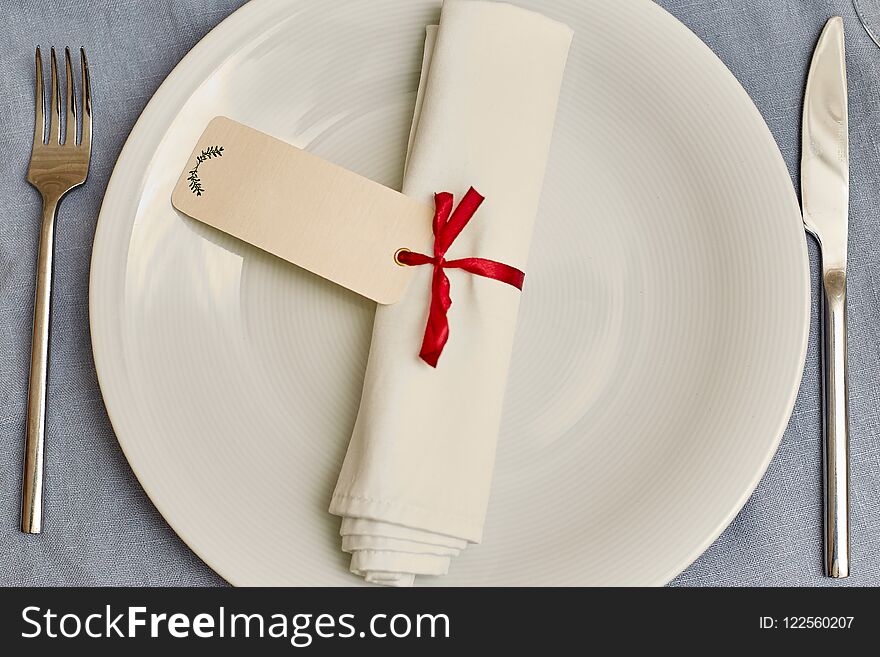 Knife, fork, plate and napkin in restaurant
