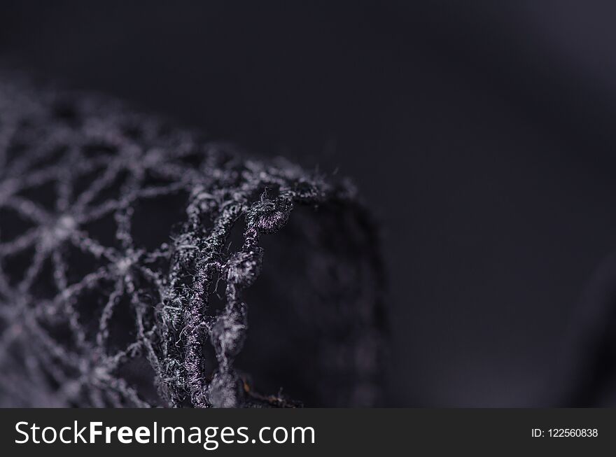 Black swimsuit bra push up seams of a string laces macro background