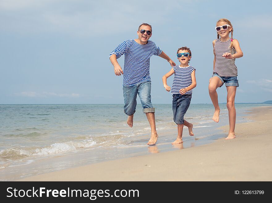 Father And Children Playing On The Beach At The Day Time.