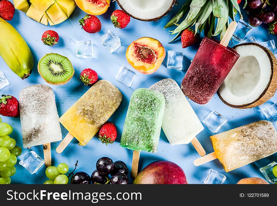 Tropical ice cream popsicles with chia seeds and fruit juices - pineapple, orange, mango, banana, kiwi, coconut, grapes, peach, strawberry, copy space. Tropical ice cream popsicles with chia seeds and fruit juices - pineapple, orange, mango, banana, kiwi, coconut, grapes, peach, strawberry, copy space