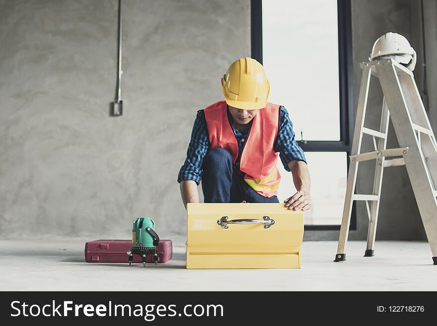 Worker Finding Tools In Construction Box In Working Site