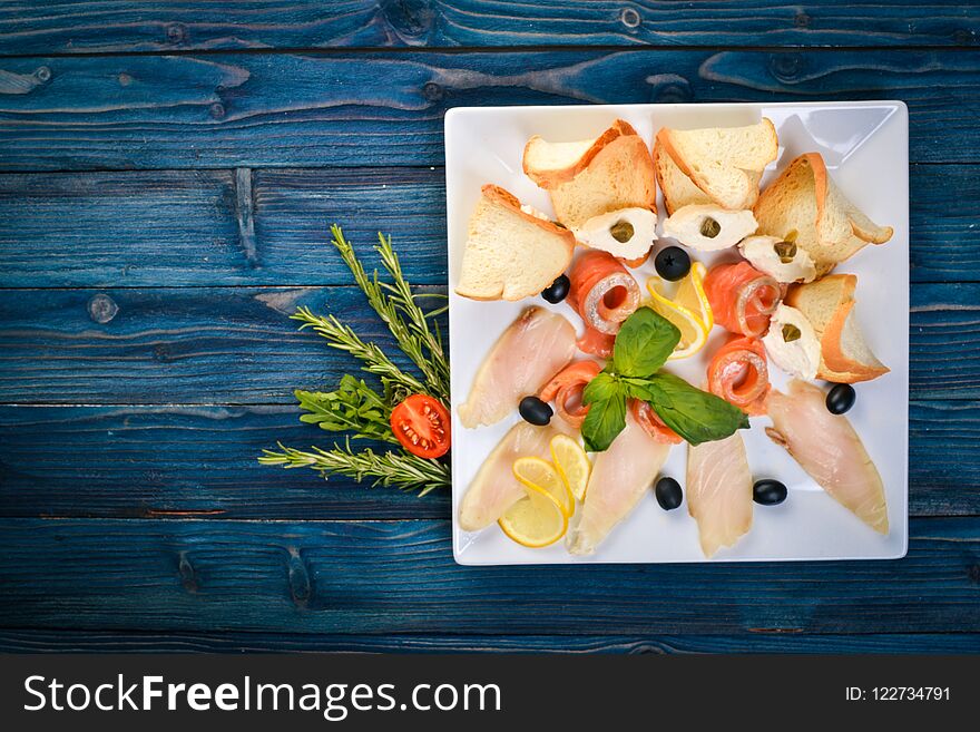 Salt fish. Salmon, pink salmon on a plate. On a wooden background. Top view. Free space for text.