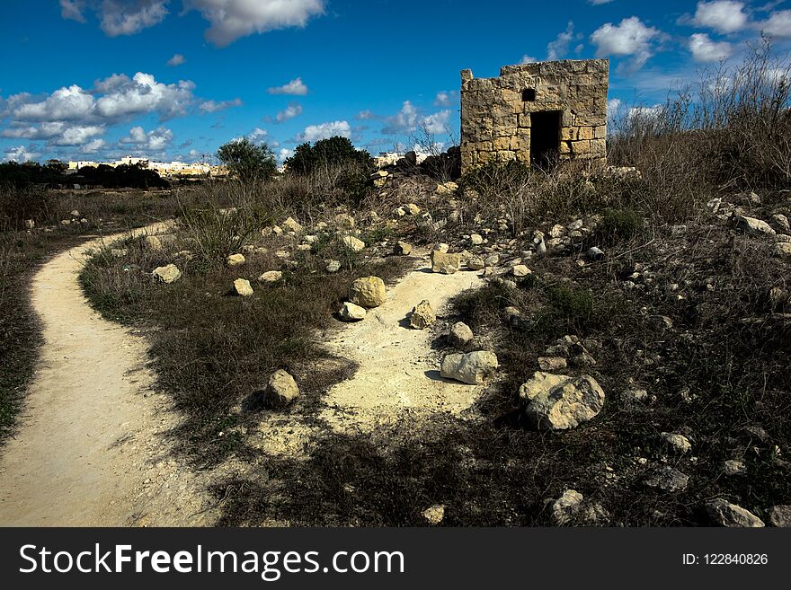 A shepherd`s house. Spilled stones. Maltese landscape. The stone plain.