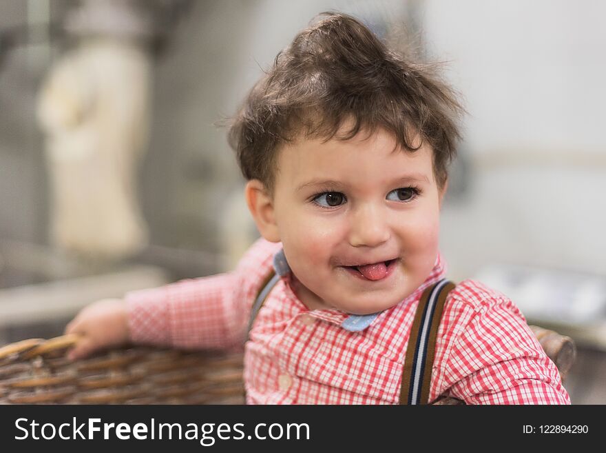 Portrait of a cute baby inside a basket in the bakery.