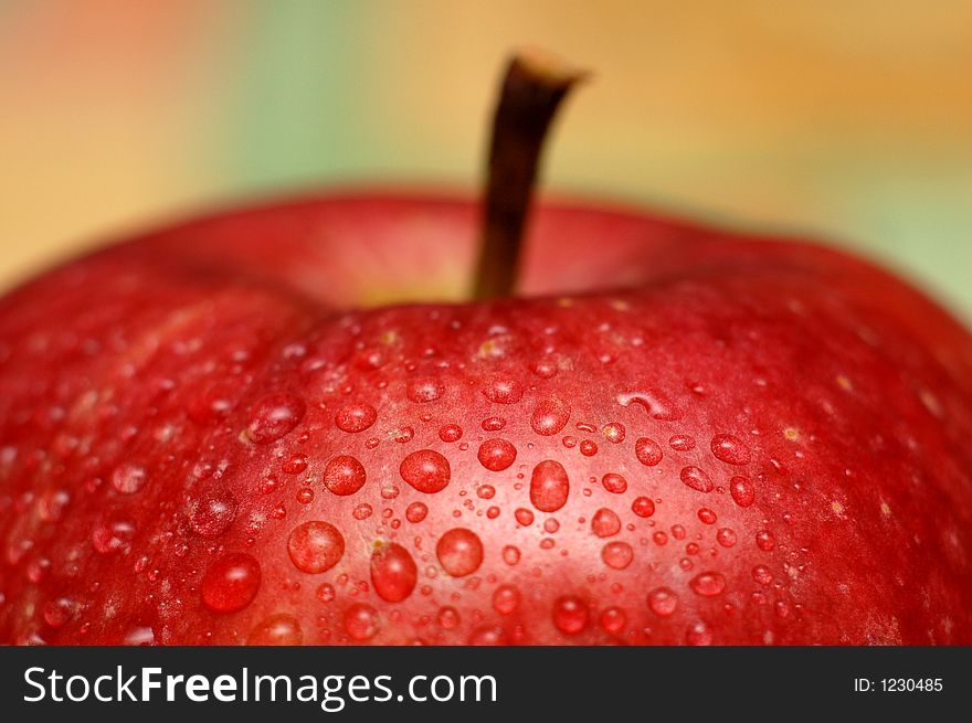 An apple covered with water droplets. An apple covered with water droplets.