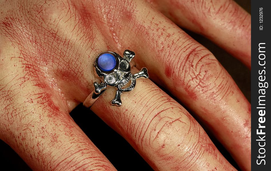 Photo of a Bloody Hand With a Skeleton Ring - Halloween Decoration