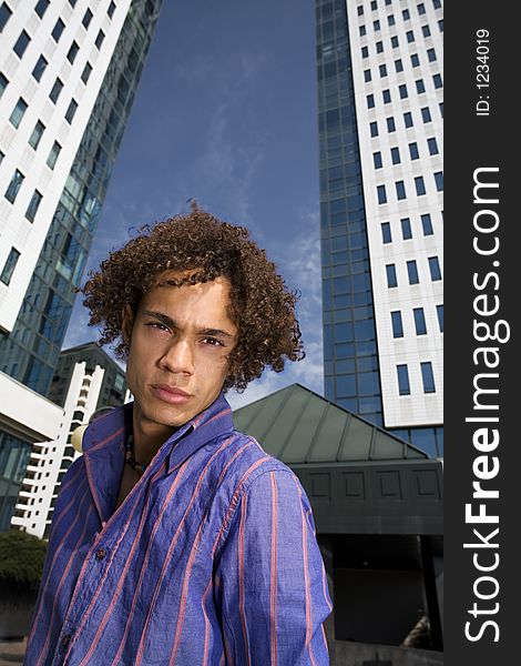 Young businessman in front of a building. Young businessman in front of a building