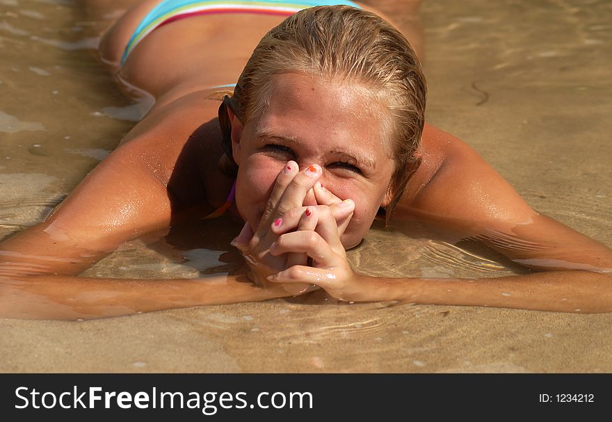 A girl in the water making faces. A girl in the water making faces