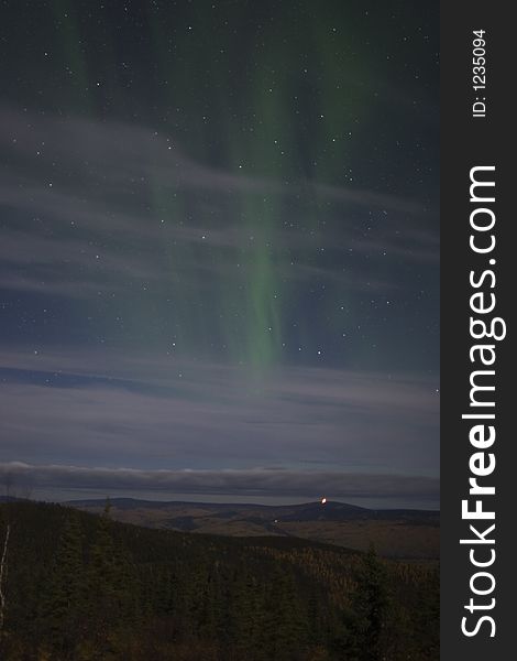Beraly visible northern lights in cloudy sky. Beraly visible northern lights in cloudy sky