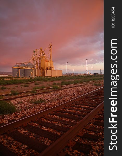 Industrial area at sunset near railroad tracks