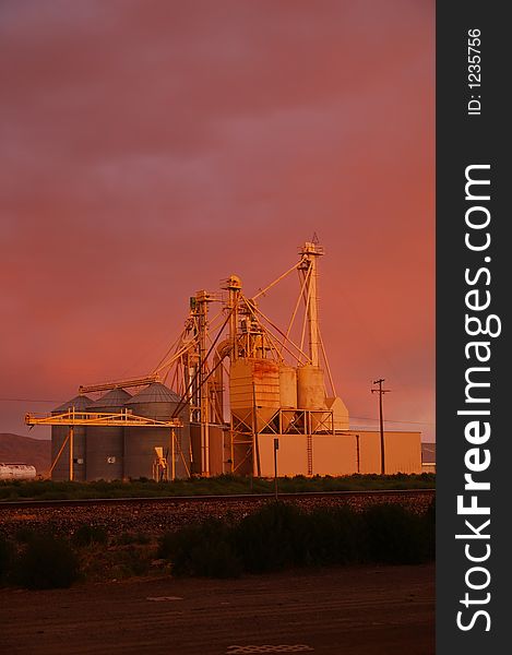 Industrial area and railroad tracks at sunset