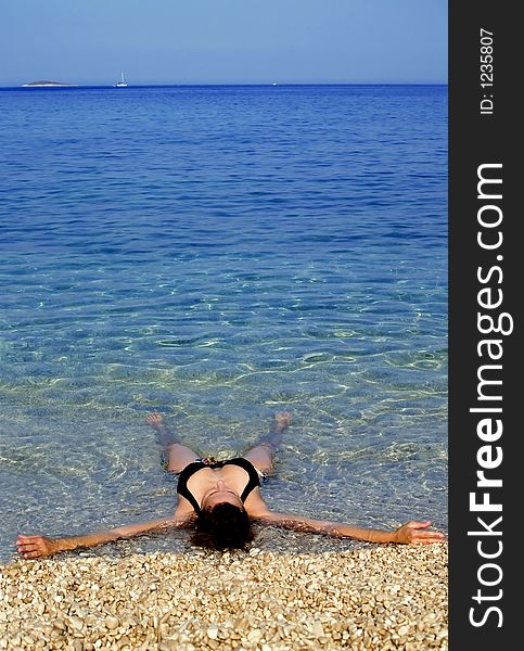Woman laying and relaxing at the sea. Woman laying and relaxing at the sea