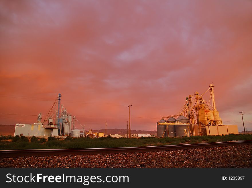 Industrial area and railroad tracks at sunset