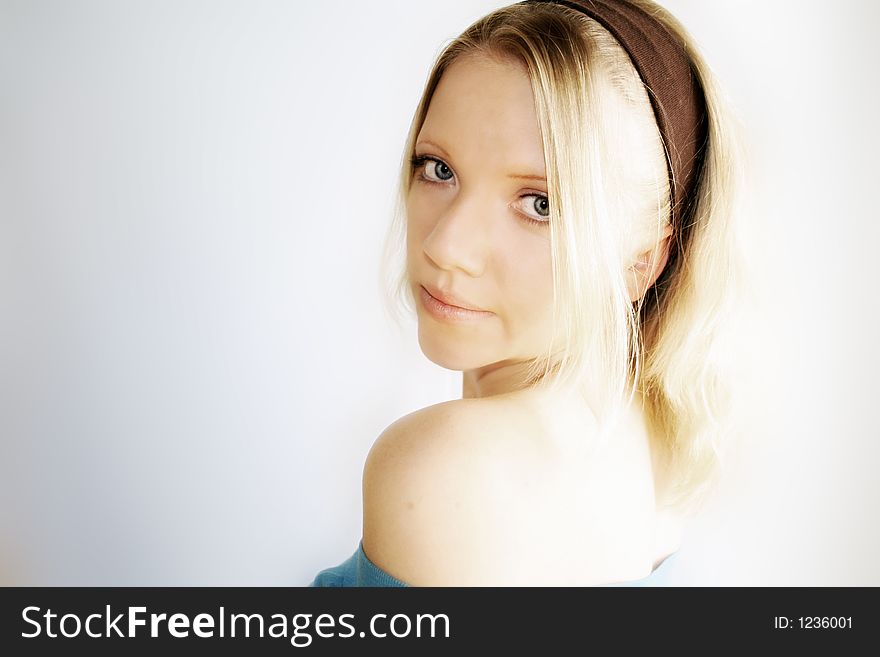 A young blond woman is smiling in the camera. A young blond woman is smiling in the camera