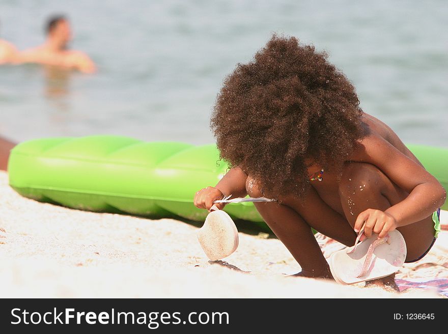 Funny hair kid playing in the sand. Funny hair kid playing in the sand