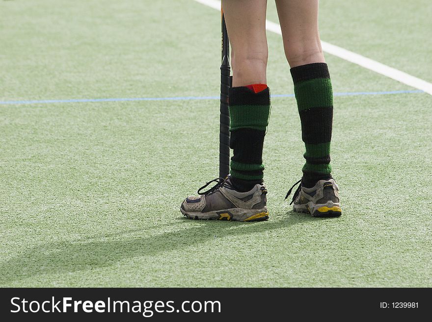 Kid standing on artificial turf playing hockey. Kid standing on artificial turf playing hockey