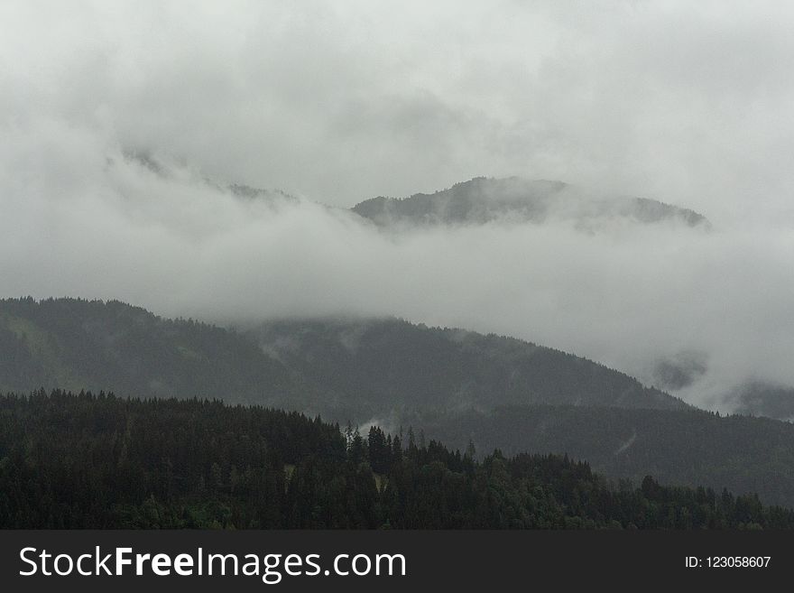 View on clouded and grey Ennstaler Alps as seen from the Hauser Kaibling mountain on a rainy morning hike.