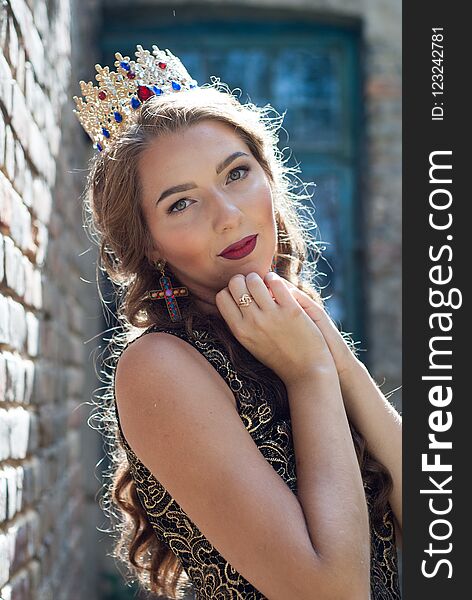 Beautiful young woman posing with a crown on her head.