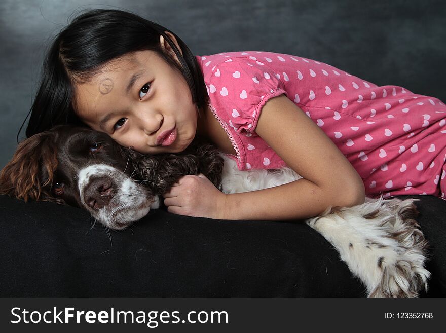 Child and dog: girl with her favorite pet shot indoor in studio
