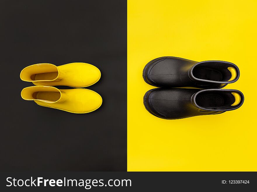 Two pairs of gumboots - yellow female and black male - standing opposite to each other on the inverse backgrounds.