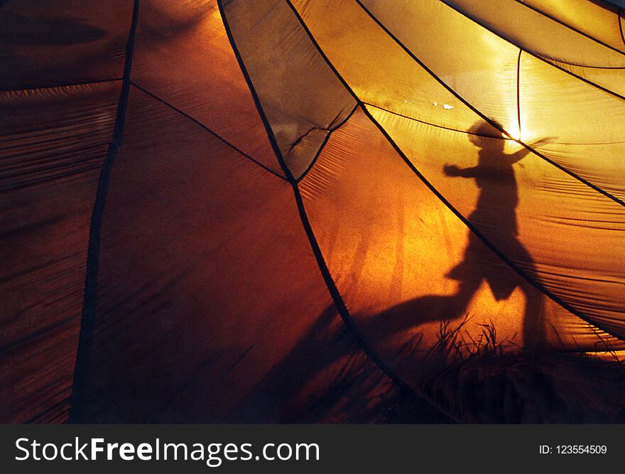 A joy to behold. A boy showing-off, dancing against a beautiful golden sunset and a makeshift tent. A joy to behold. A boy showing-off, dancing against a beautiful golden sunset and a makeshift tent.