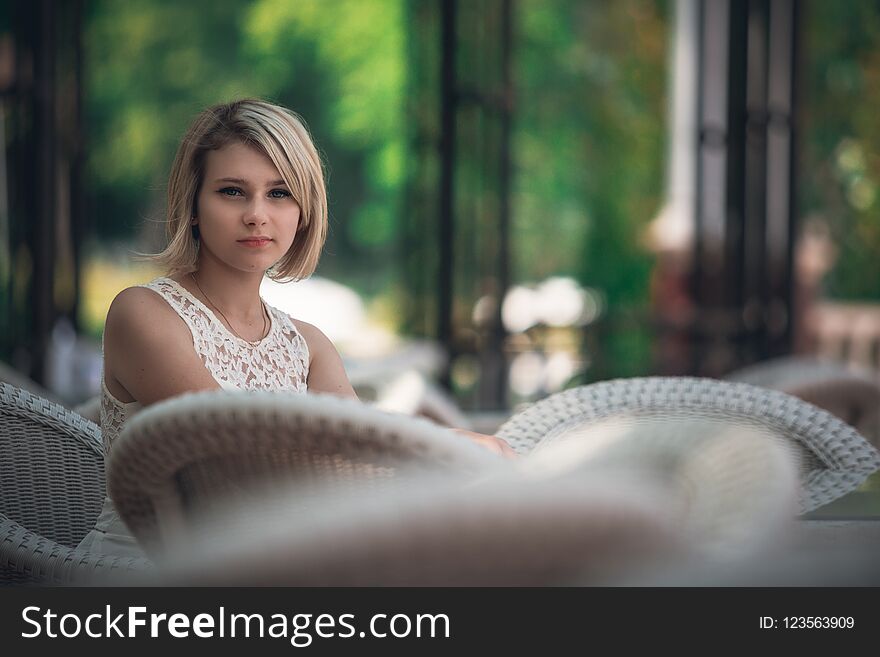 Portrait of a beautiful young woman at a table in a cafe
