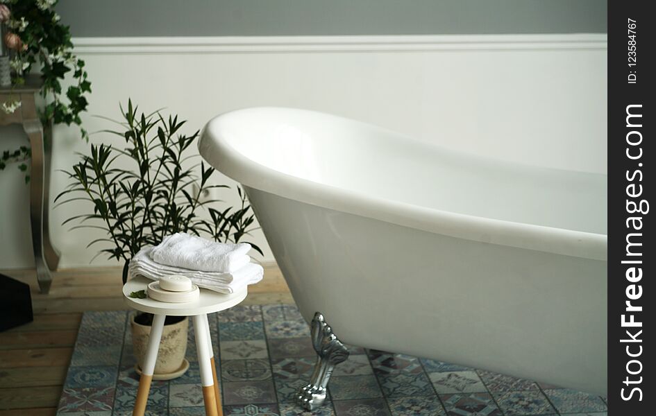 Interior with white bath and room colors. bath accessories. bath with silver legs. bathroom design. Interior with white bath and room colors. bath accessories. bath with silver legs. bathroom design