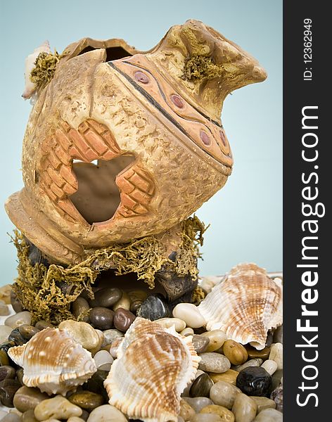 Ancient vase with stones and seashell