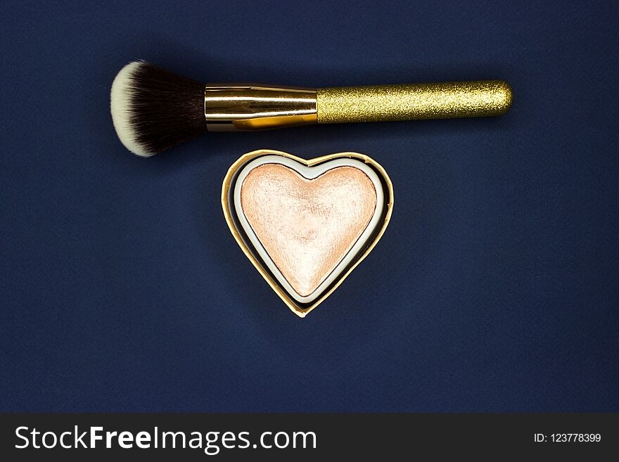 Brush For Make-up And Powder-gloss On A Blue Background