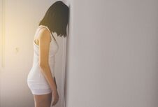 Asian Woman Depression Have A Headache And Feeling Sadness Alone In Bedroom,Head Against The Wall Royalty Free Stock Image
