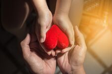 Adults And Children Are Holding A Red Heart Stock Photos
