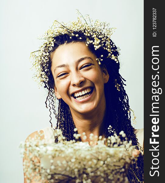 Young pretty brunette girl with bouquet of little white spring f