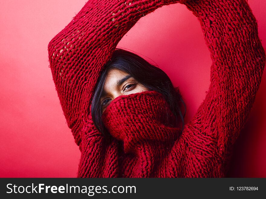 Young pretty indian mulatto girl in red sweater posing emotional, fashion hipster teenage, lifestyle people concept close up