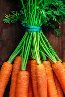 Fresh Carrots Bunch On Rustic Wooden Background With Copy Space. Royalty Free Stock Photos