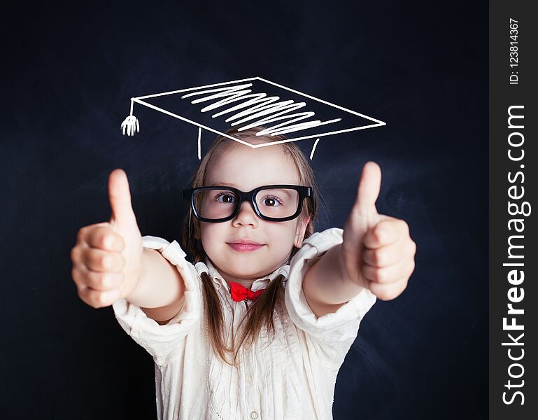 Cute Schoolgirl Wearing Graduation Hat Showing Thumb Up