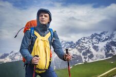 Portrait Of Hiker In Mountains In Sportswear. Tourist Is On Hiking Trek. Adventure Hike Along Hills And Mountains Stock Photo