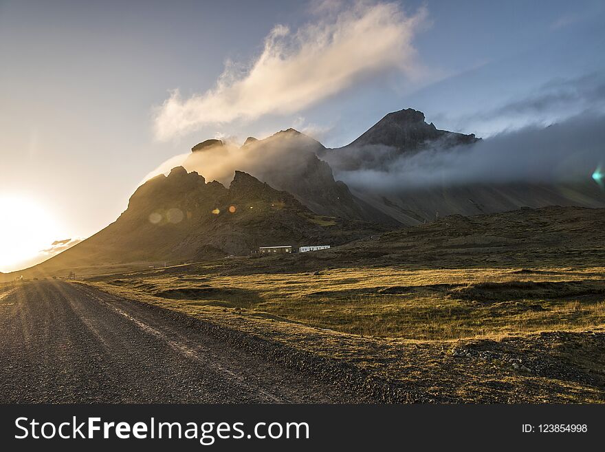 Sunset in Stokksnes, Iceland with Vestrahorn mountain visible, partially obscured by clouds. Sunset in Stokksnes, Iceland with Vestrahorn mountain visible, partially obscured by clouds.