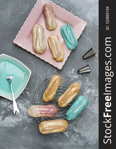 Eclairs with color glaze on gray background
