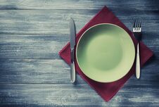Plate, Knife And Fork At Napkin On Wood Stock Photos