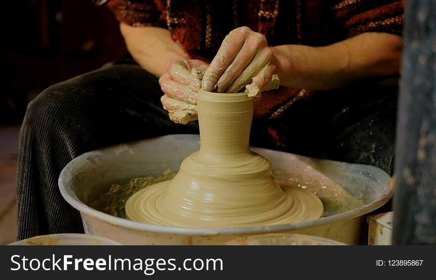 Professional male potter making mug in pottery workshop, studio. Handmade, art and handicraft concept